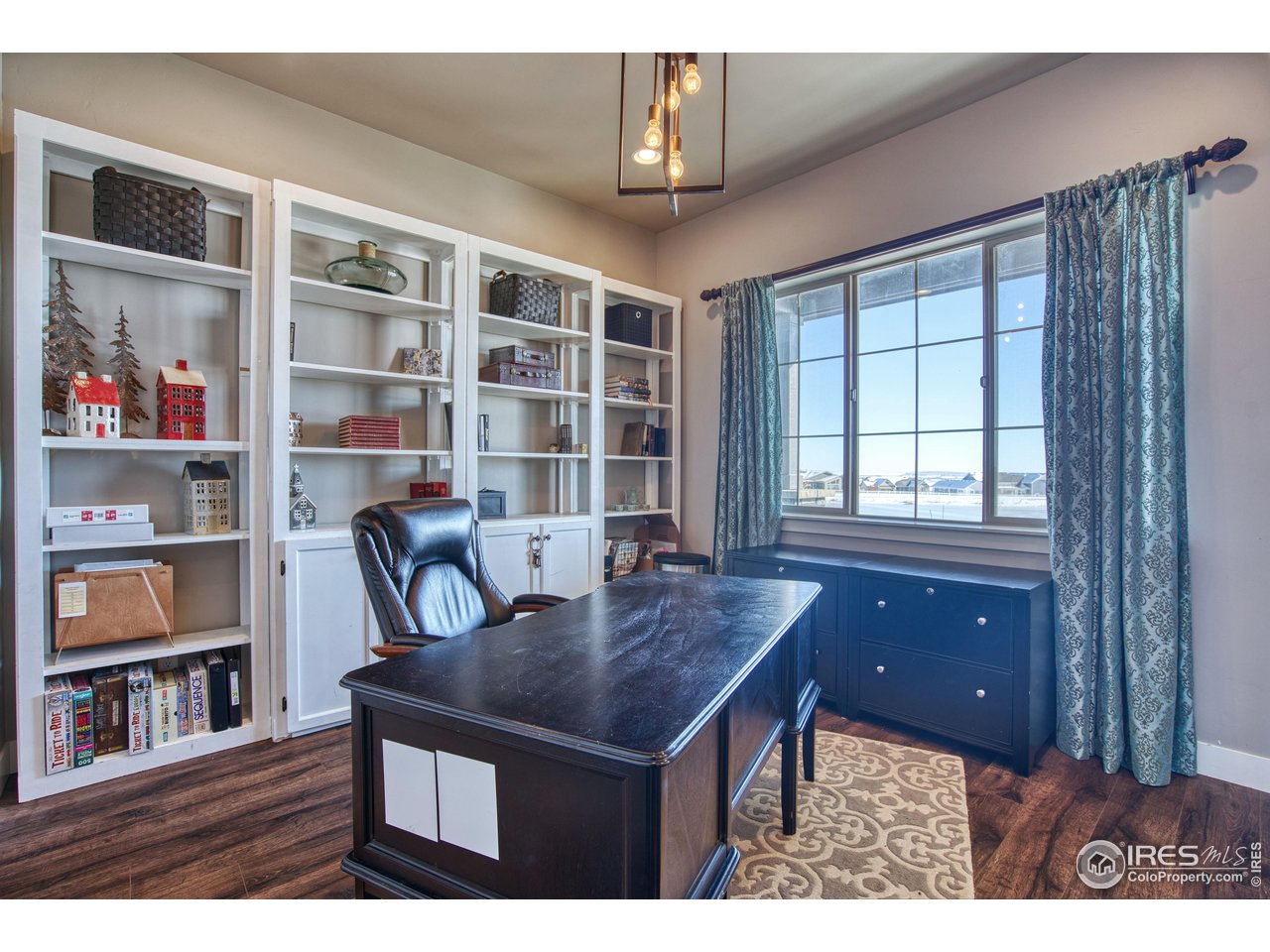 3941 Roper Trail Severance, CO 80524 - Photo 17 of 32 a view of a workspace with furniture and a window
