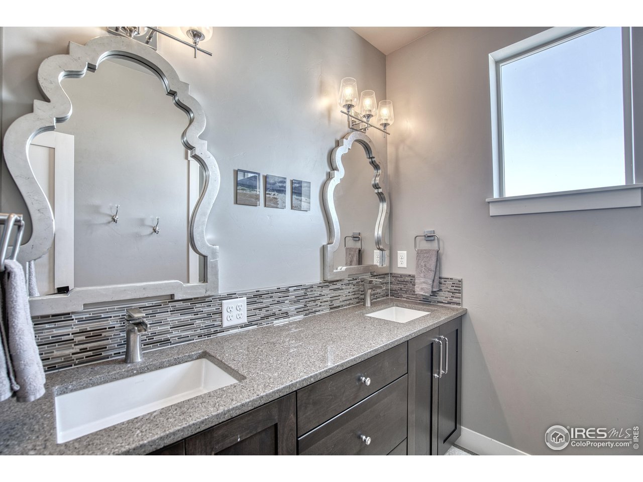 3941 Roper Trail Severance, CO 80524 - Photo 22 of 32 a bathroom with a sink double vanity and a mirror