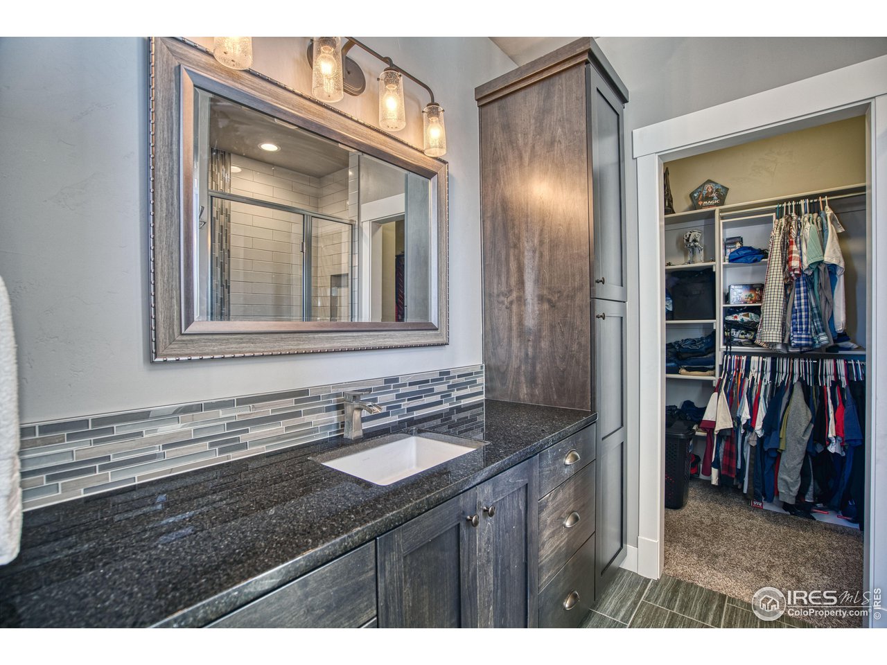 3941 Roper Trail Severance, CO 80524 - Photo 26 of 32 a bathroom with a sink and a mirror