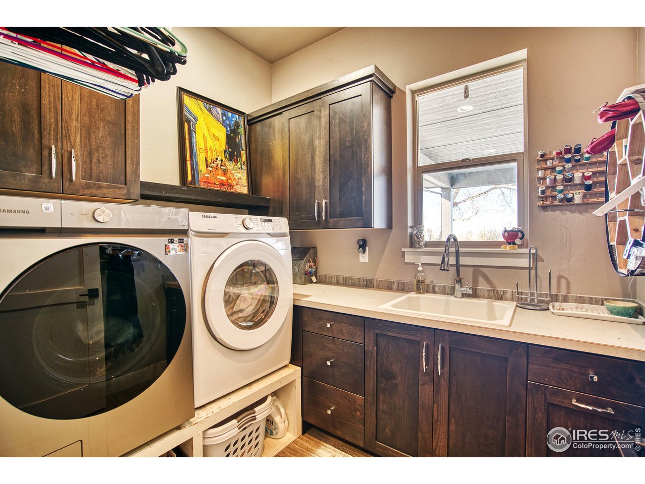 3941 Roper Trail Severance, CO 80524 - Photo 28 of 32 a bathroom with a sink a washer and dryer