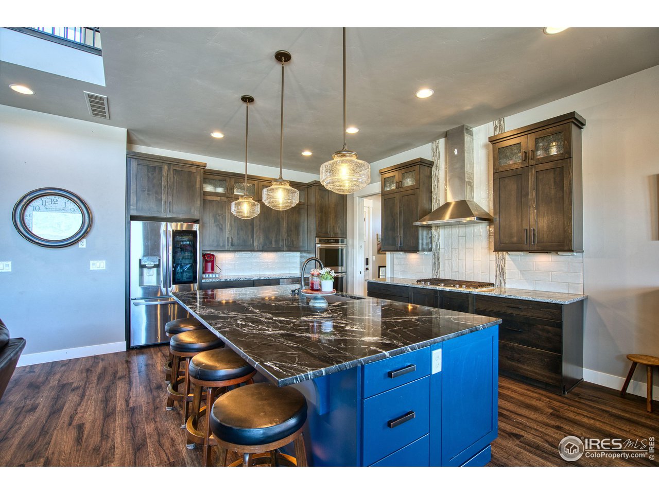 3941 Roper Trail Severance, CO 80524 - Photo 8 of 32 a kitchen with stainless steel appliances granite countertop a sink a stove a counter space and cabinets
