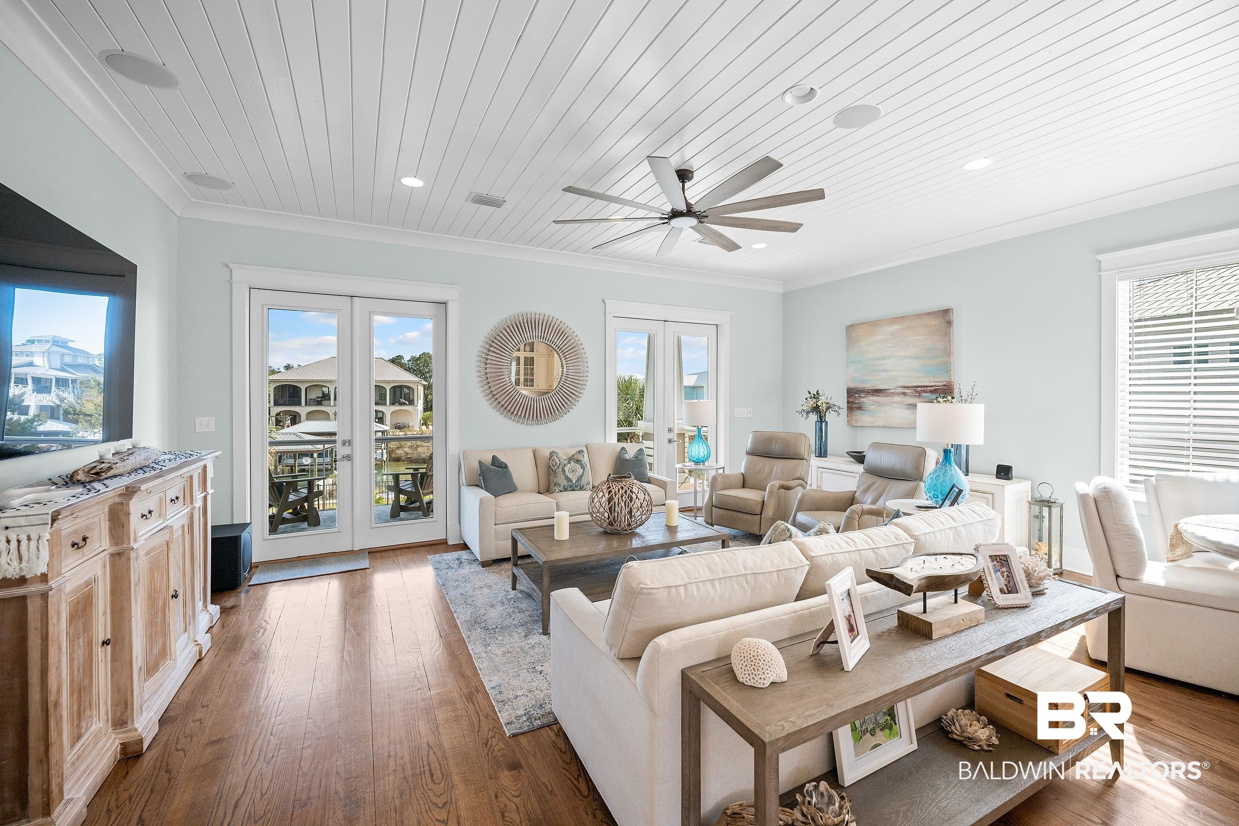 33186 Marlin Key Drive Orange Beach, AL 36561 - Photo 44 of 87 Living room with french doors, dark wood-type flooring, ceiling fan, ornamental molding, and wooden ceiling