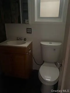 a bathroom with a toilet sink and mirror