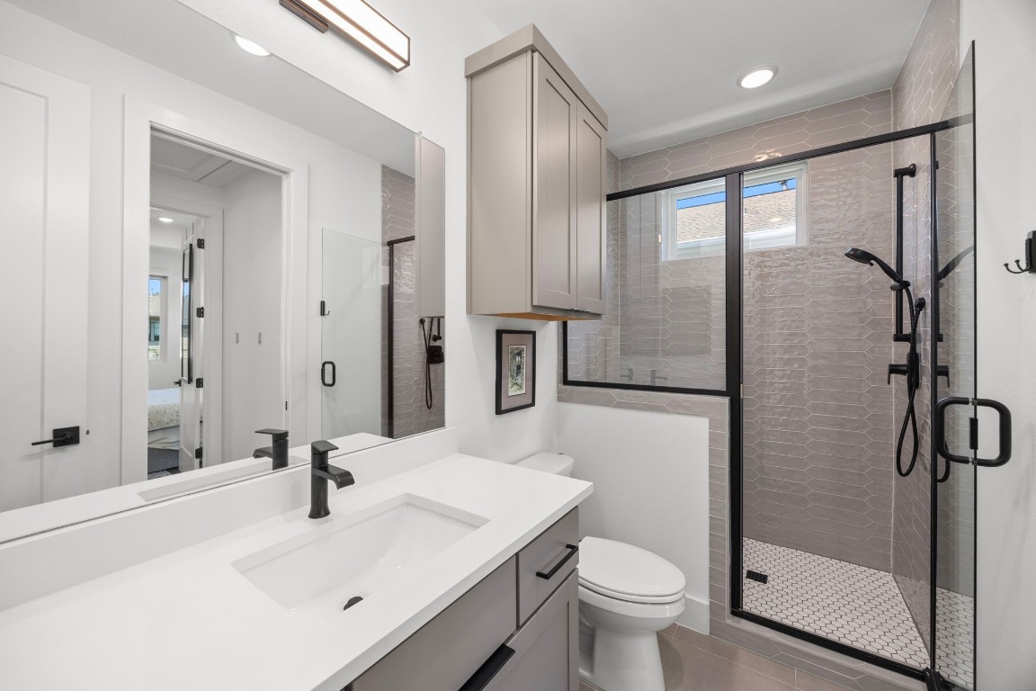 424 Redan Street Houston, TX 77009 - Photo 18 of 47 a bathroom with a sink toilet and shower