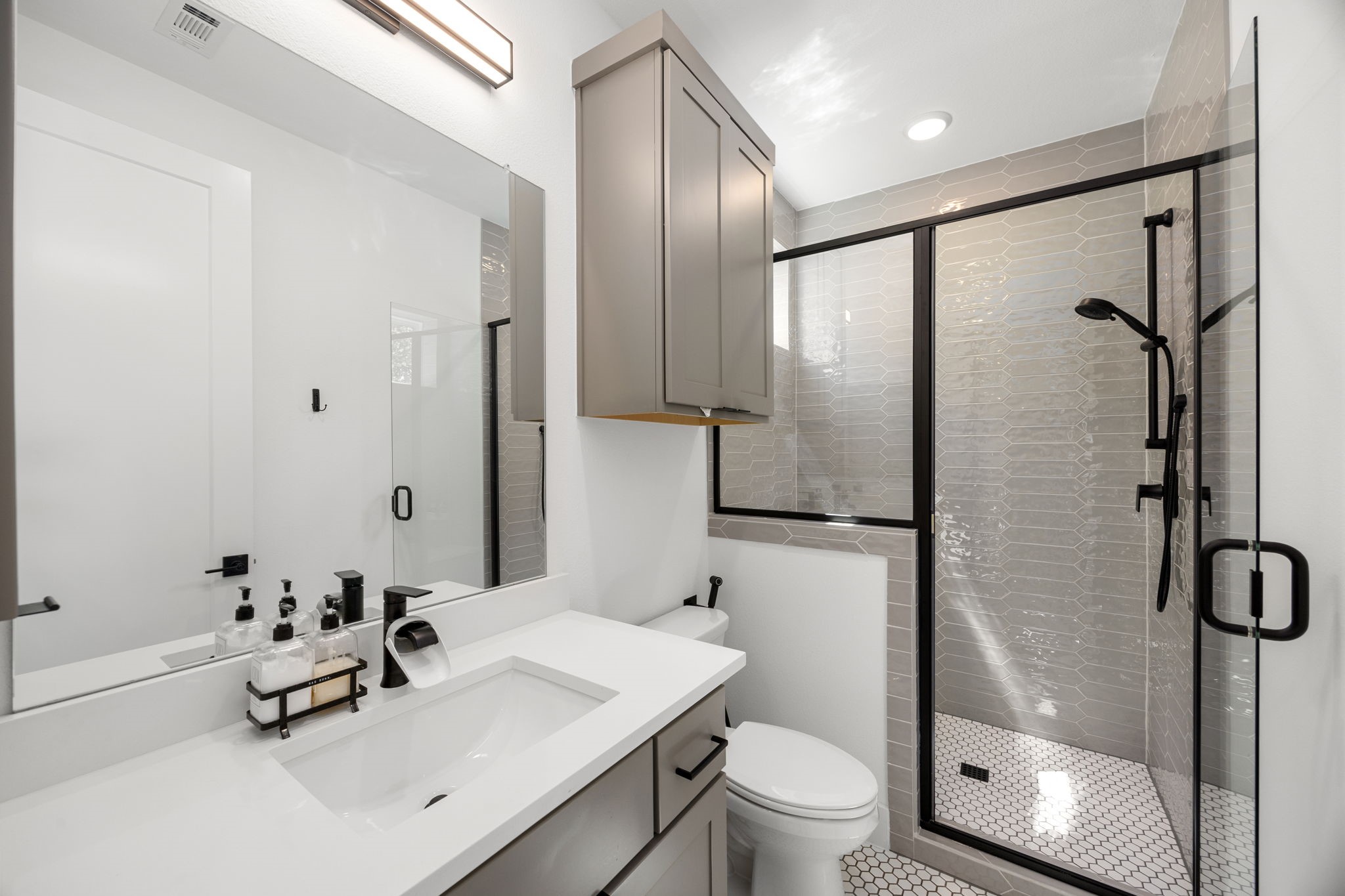 424 Redan Street Houston, TX 77009 - Photo 20 of 47 a bathroom with a sink toilet and shower