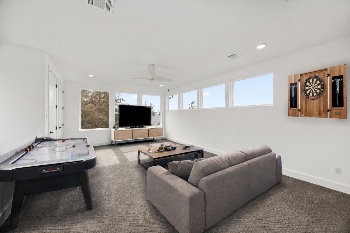 424 Redan Street Houston, TX 77009 - Photo 23 of 47 a living room with furniture and a flat screen tv