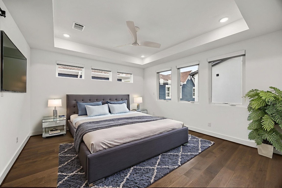 424 Redan Street Houston, TX 77009 - Photo 25 of 47 a bedroom with a large bed and a potted plant