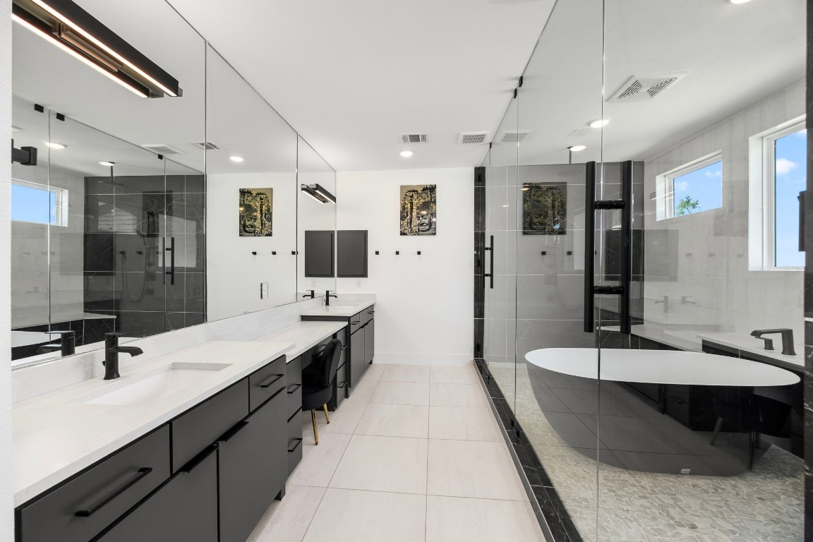 424 Redan Street Houston, TX 77009 - Photo 29 of 47 a large bathroom with a double vanity sink a mirror and shower