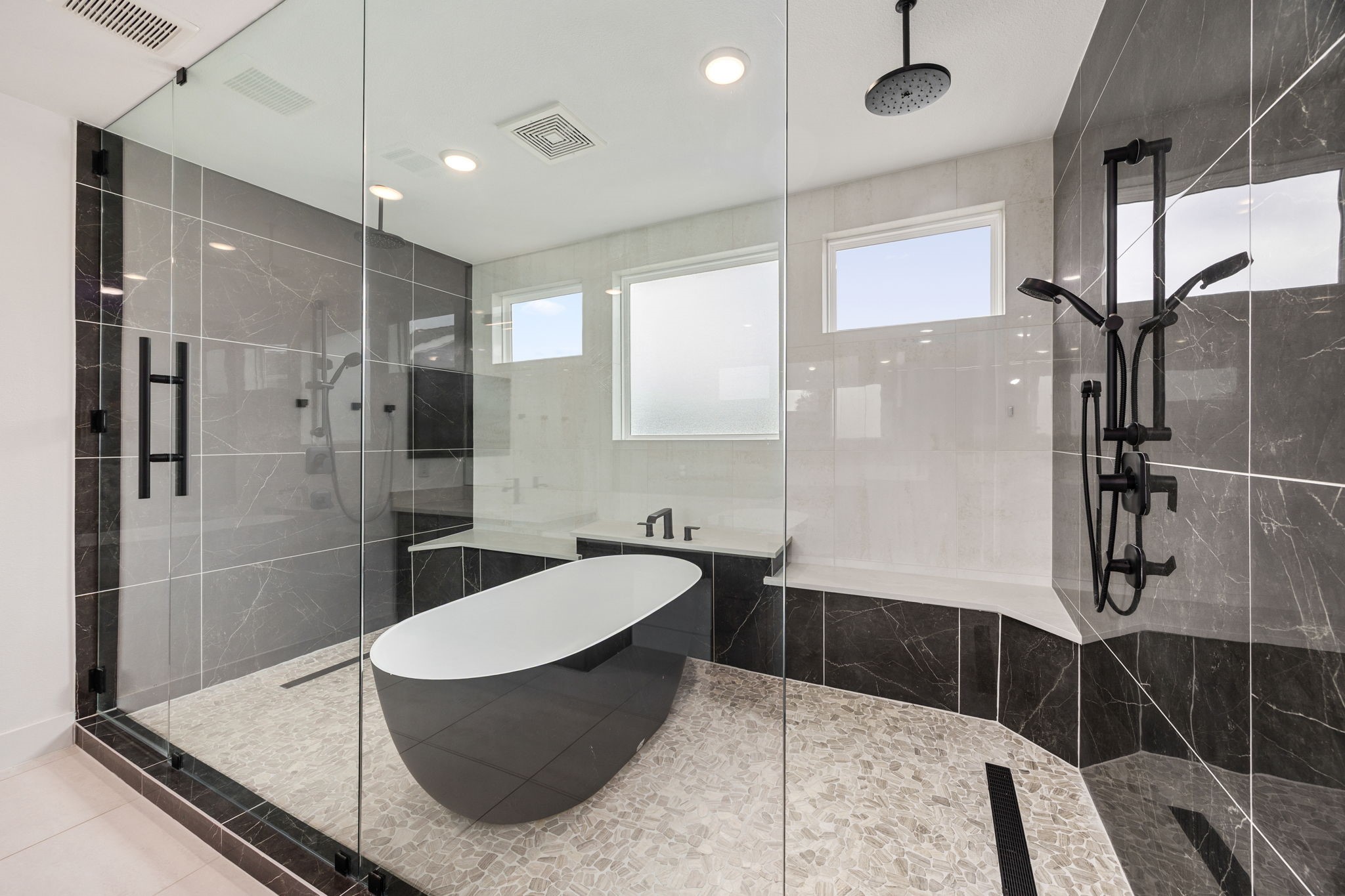 424 Redan Street Houston, TX 77009 - Photo 30 of 47 a bathroom with a tub sink shower and mirror