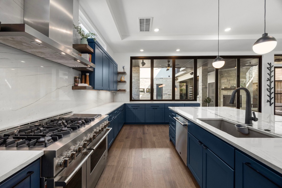 424 Redan Street Houston, TX 77009 - Photo 3 of 47 a kitchen with a stove a sink a bath tub and a counter space