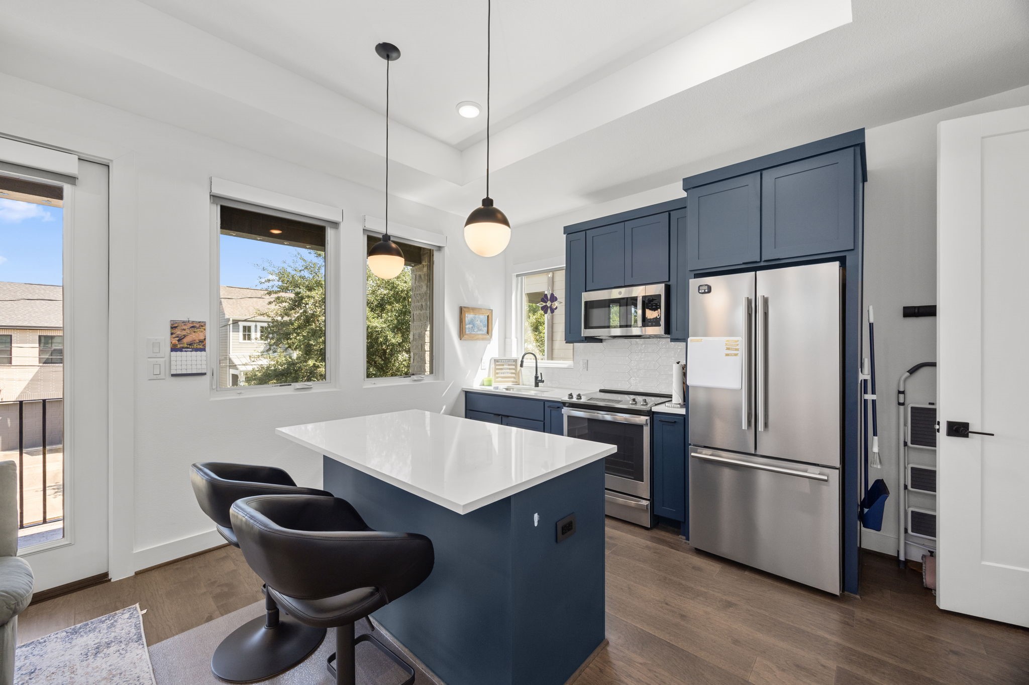 424 Redan Street Houston, TX 77009 - Photo 35 of 47 a kitchen with granite countertop a refrigerator a stove a kitchen island with a dining table and wooden floor