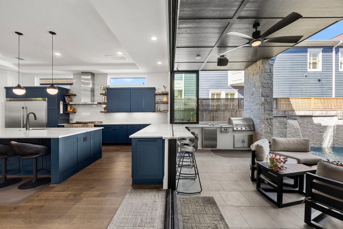 424 Redan Street Houston, TX 77009 - Photo 7 of 47 a kitchen with stainless steel appliances kitchen island granite countertop a sink and a refrigerator