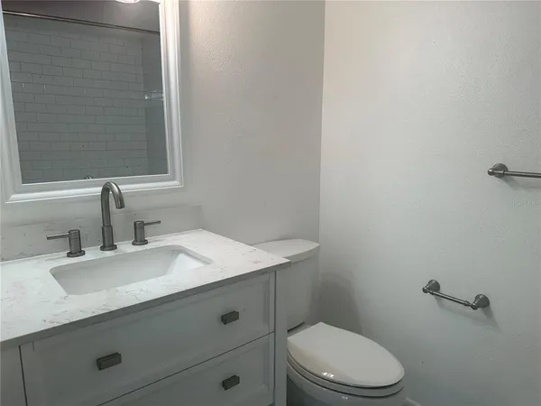 a bathroom with a sink a toilet and vanity