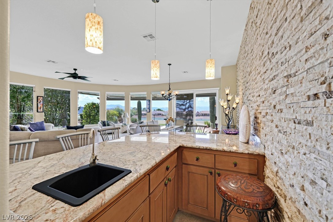 1823 Baton Rouge Street Henderson, NV 89052 - Photo 55 of 60 An open floor plan connects the stone-accented wet bar to the living area.