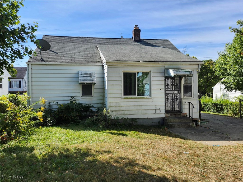 16907 Ridgeton Drive Cleveland, OH 44128 - Photo 22 of 25 Rear view of house with a lawn