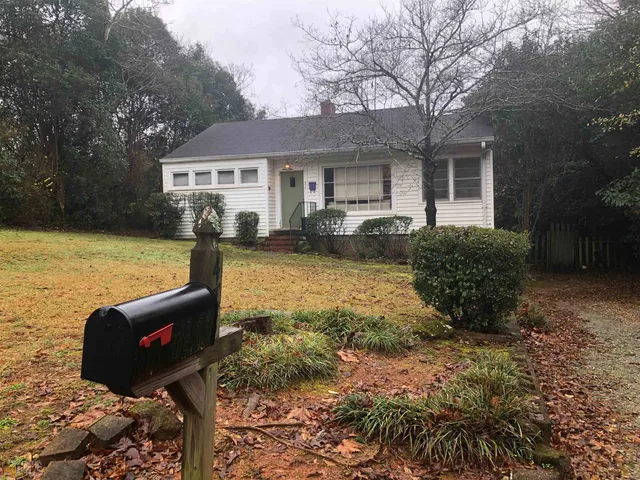 a front view of house with yard and trees
