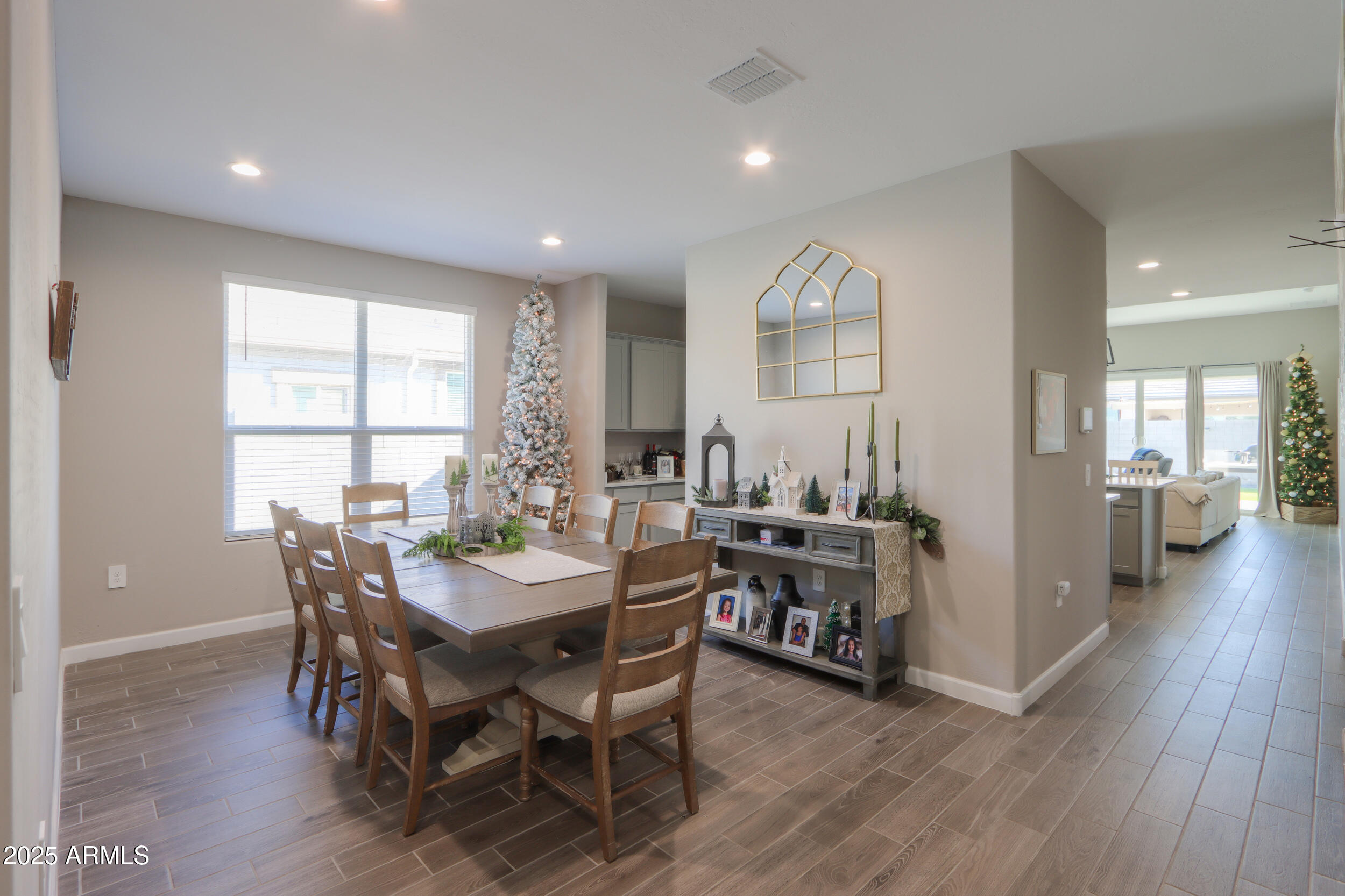 44583 West Palo Olmo Road Maricopa, AZ 85138 - Photo 12 of 43 a view of a dining room with furniture and wooden floor