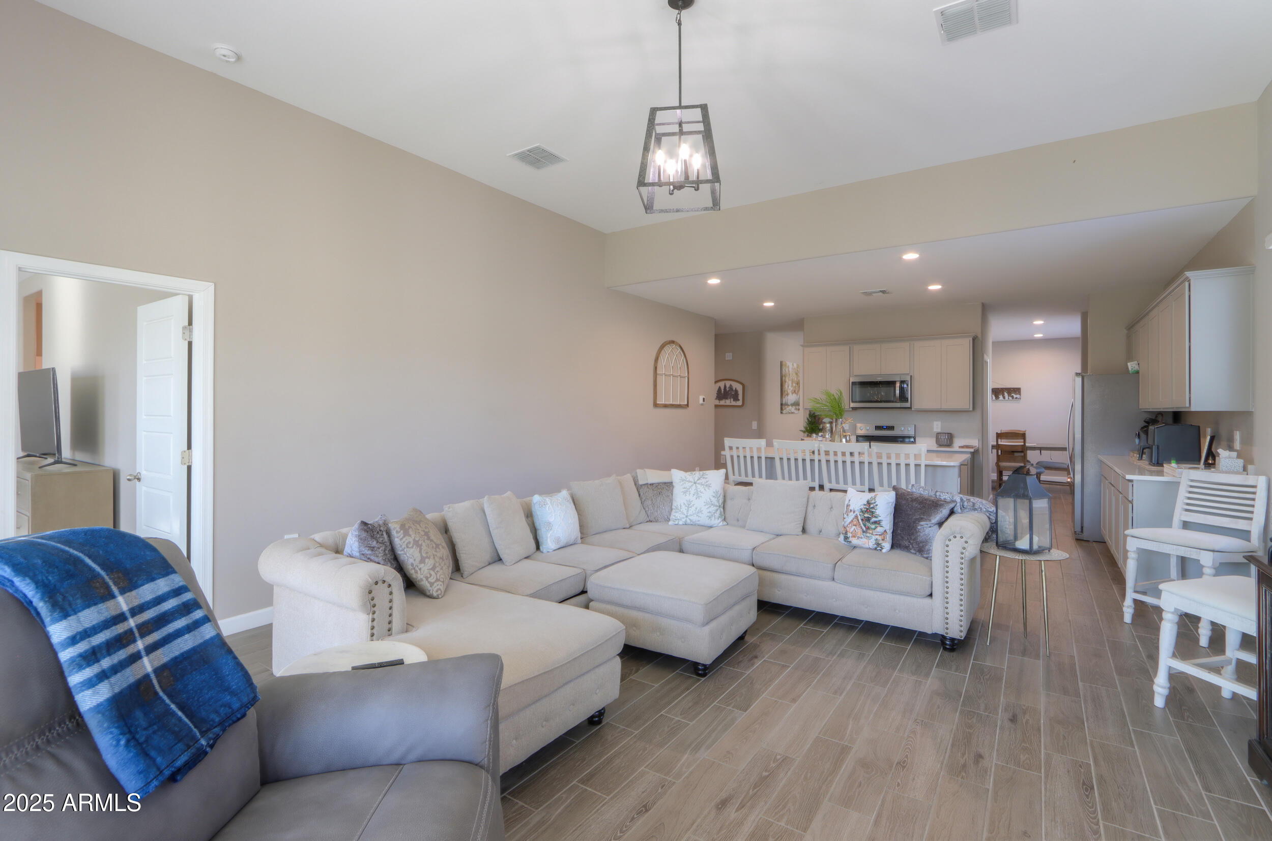 44583 West Palo Olmo Road Maricopa, AZ 85138 - Photo 19 of 43 a living room with furniture kitchen view and a chandelier