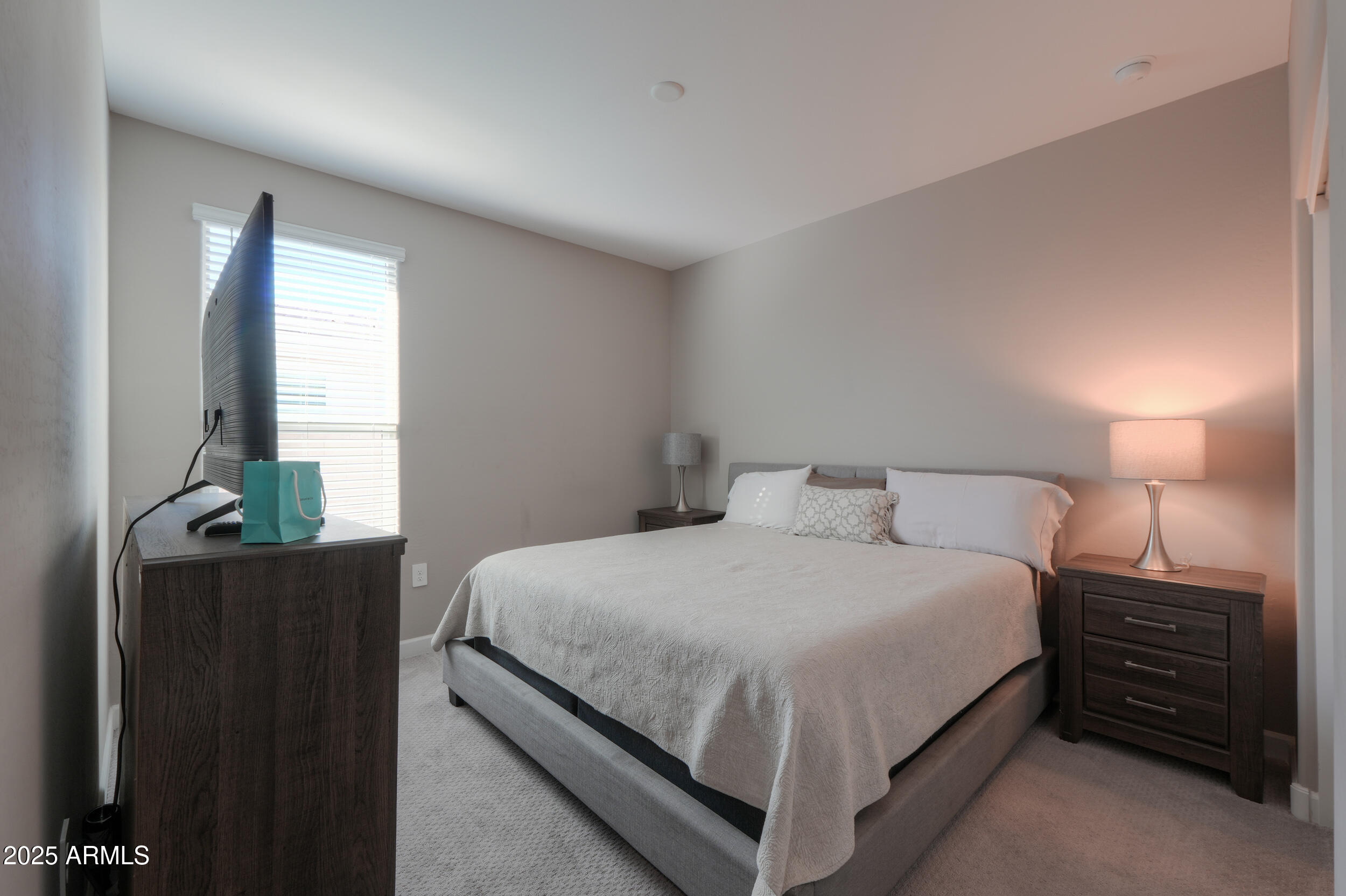 44583 West Palo Olmo Road Maricopa, AZ 85138 - Photo 23 of 43 a bedroom with a bed and a night stand