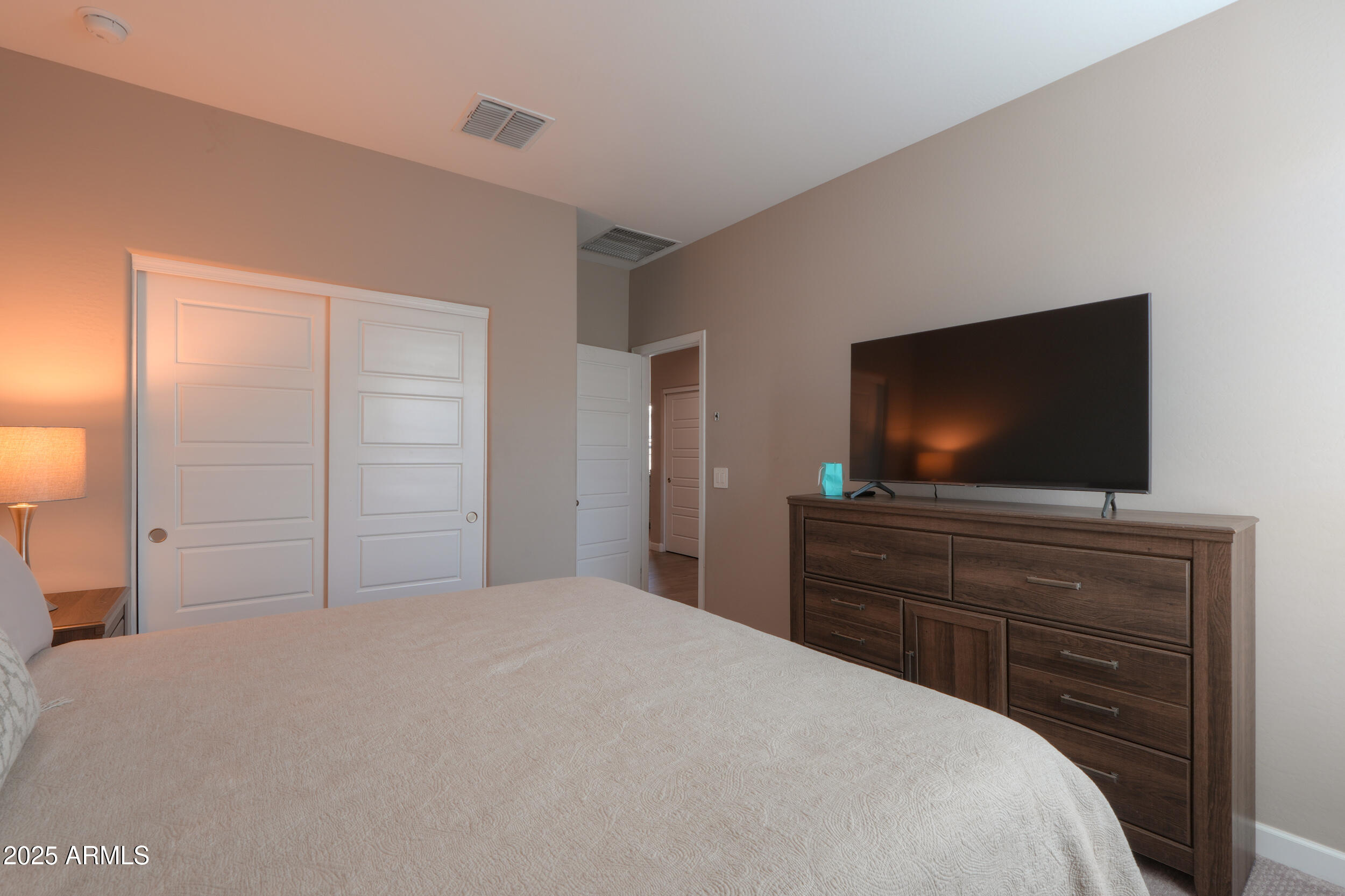 44583 West Palo Olmo Road Maricopa, AZ 85138 - Photo 24 of 43 a bedroom with a bed and a flat screen tv