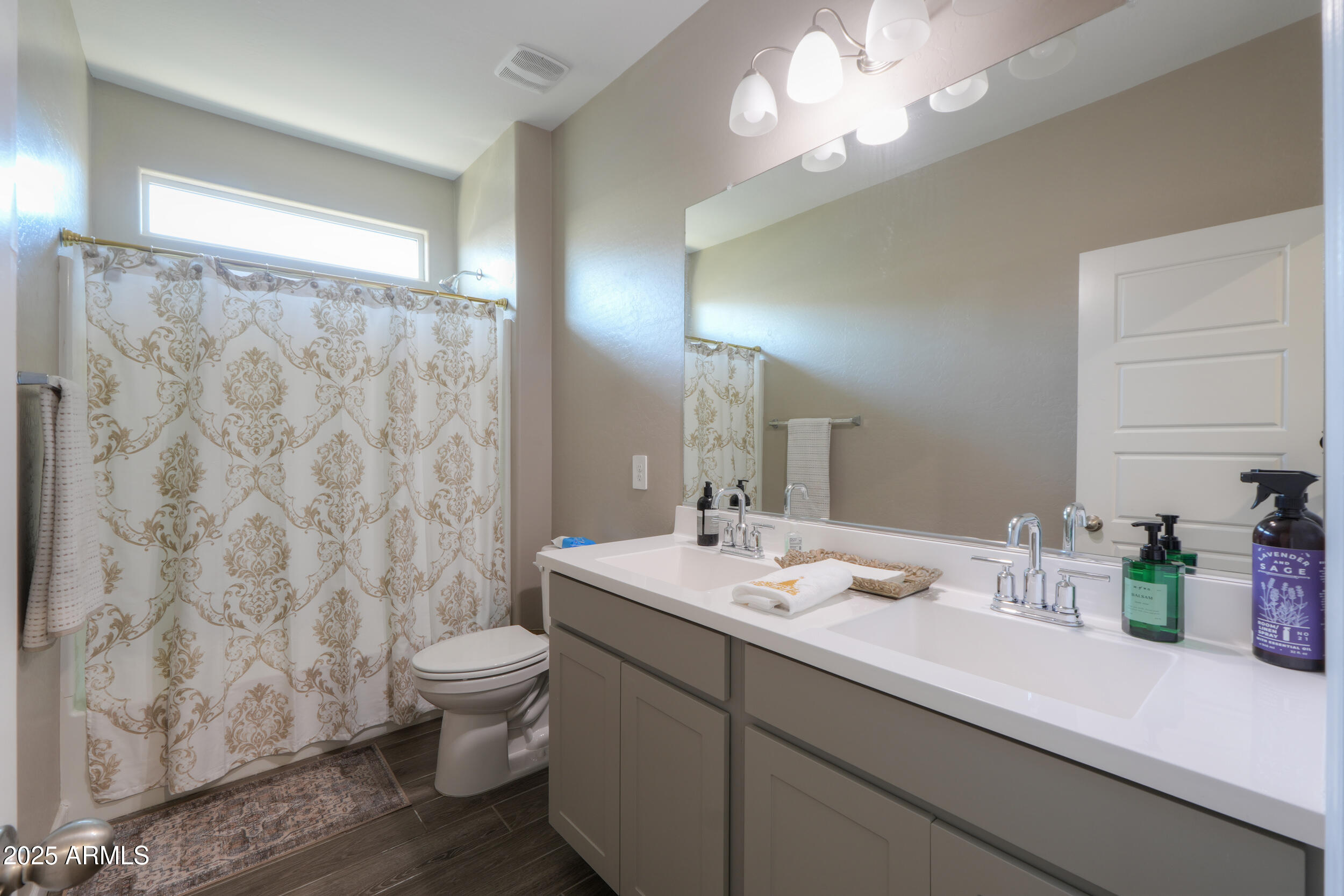 44583 West Palo Olmo Road Maricopa, AZ 85138 - Photo 25 of 43 a bathroom with a sink a toilet and a large mirror