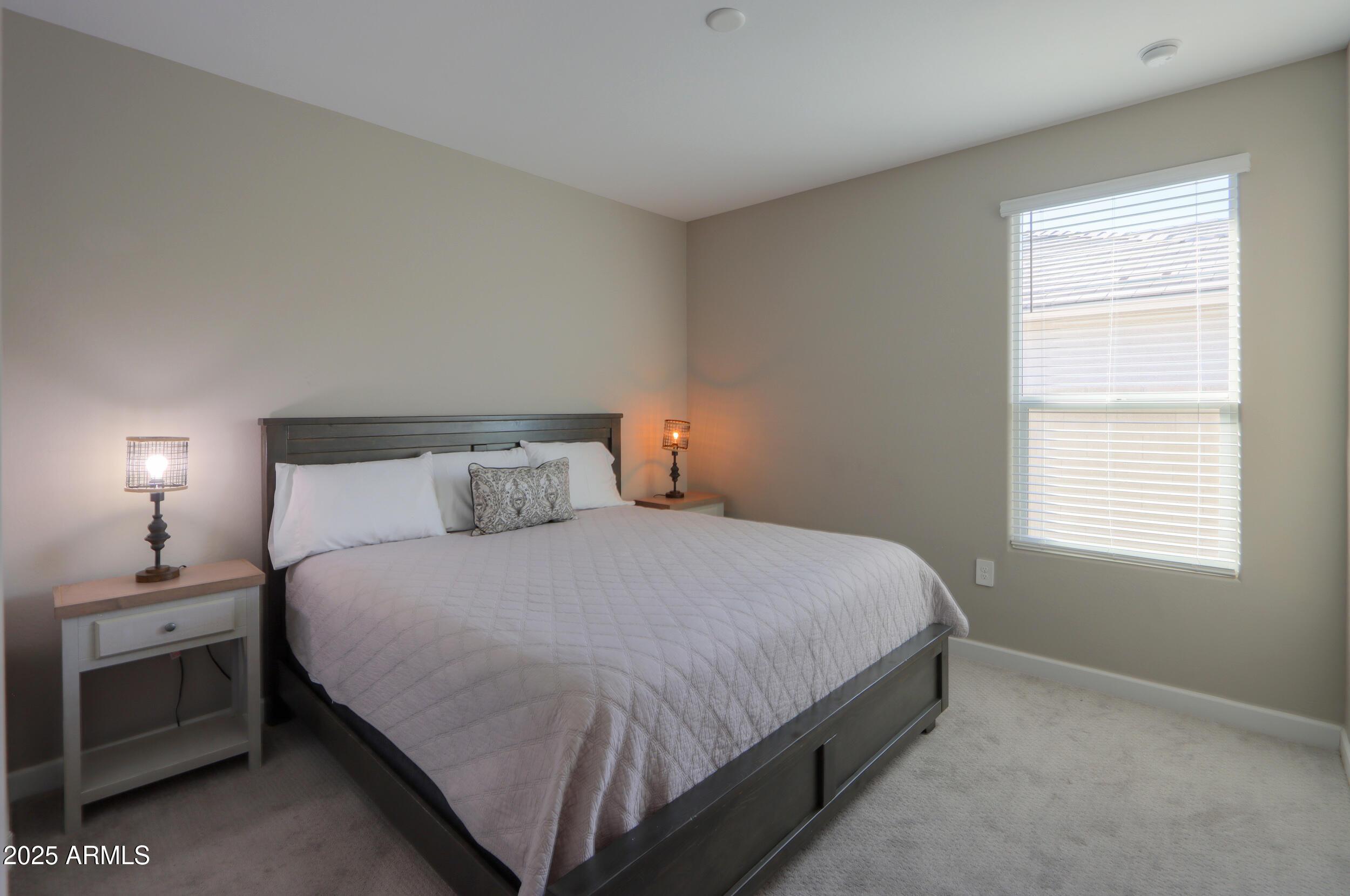 44583 West Palo Olmo Road Maricopa, AZ 85138 - Photo 26 of 43 a bedroom with a bed and a lamp