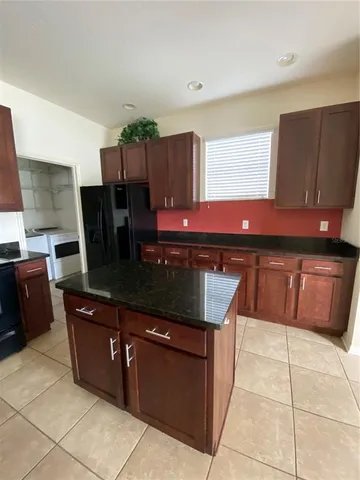 a kitchen with stainless steel appliances wooden cabinets and a sink