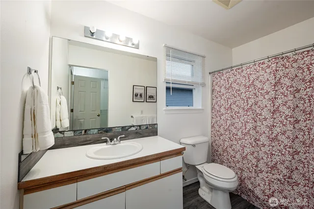 a bathroom with a sink toilet and mirror