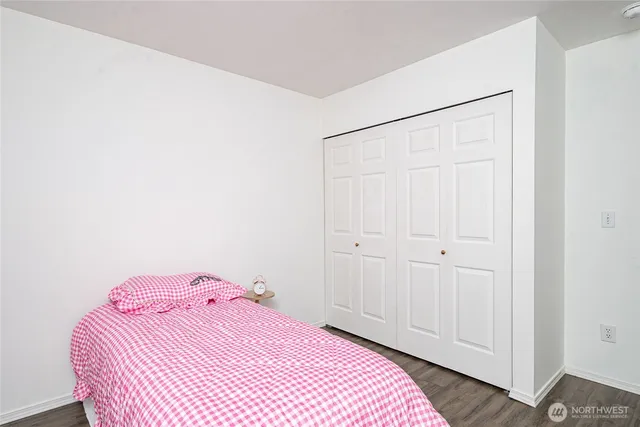 a bedroom with a bed and a closet