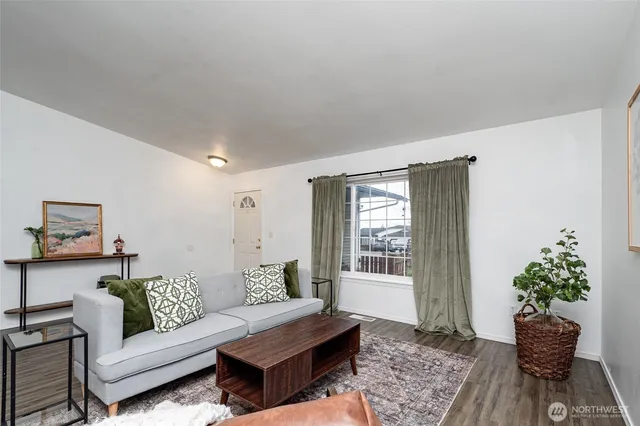a living room with furniture and a potted plant