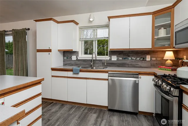 a kitchen that has a sink and a stove