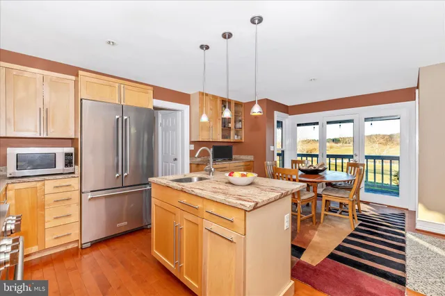 a bedroom with a bed a table and wooden floor