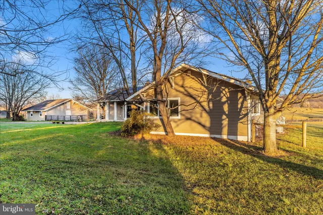 a view of a dining room with furniture large windows and wooden floor