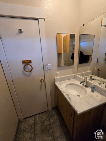1025 North 300 West, Unit 1 Springville, UT 84663 - Photo 15 of 35 Bathroom with vanity, dark tile patterned flooring, and a textured wall