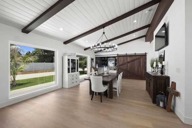 a kitchen with stainless steel appliances a sink a stove and white cabinets next to a window
