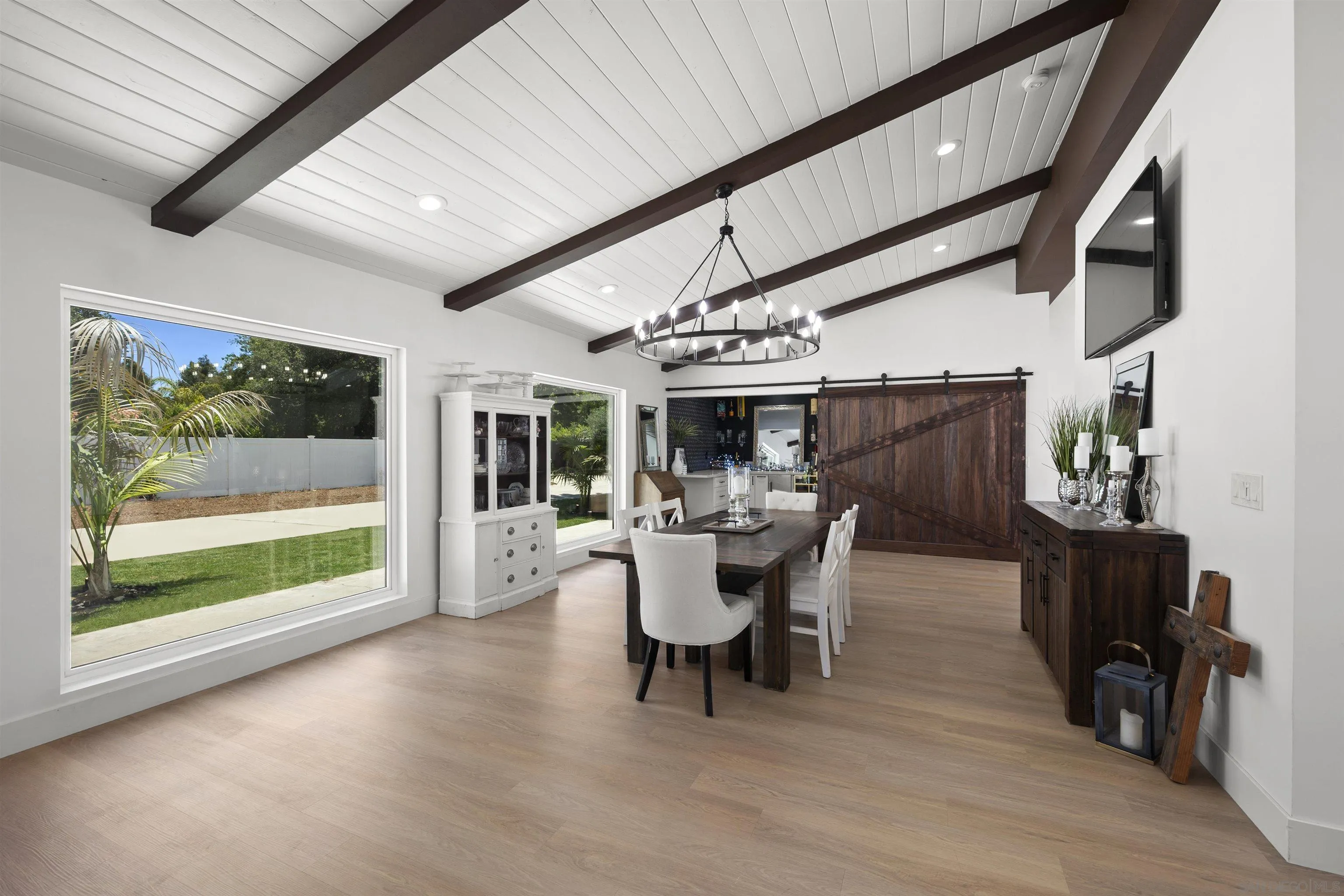 13367 Calle Colina Poway, CA 92064 - Photo 12 of 60 a dining room with furniture wooden floor a flat screen tv and a fireplace