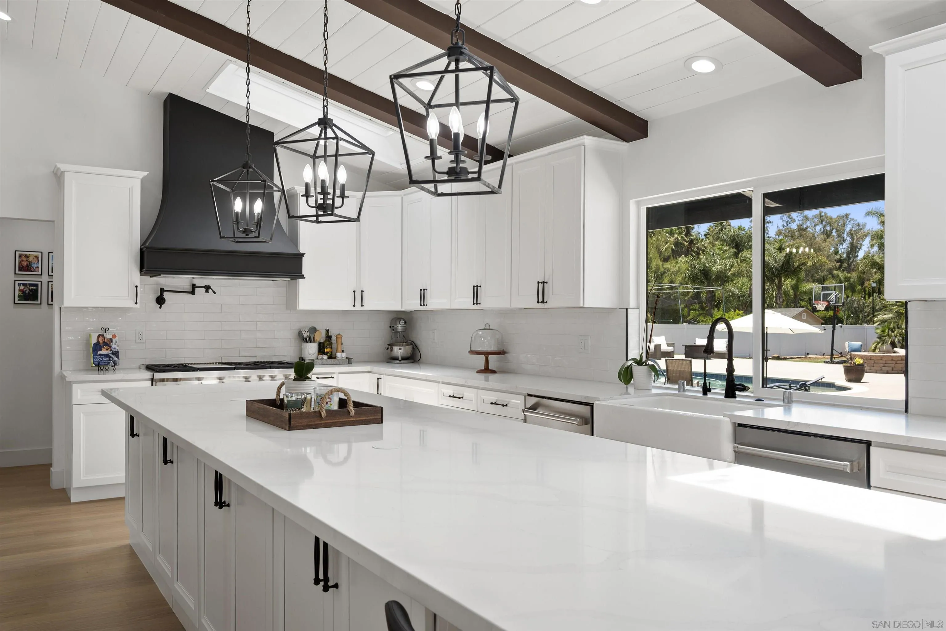 13367 Calle Colina Poway, CA 92064 - Photo 16 of 60 a kitchen with stainless steel appliances a sink a stove and white cabinets next to a window