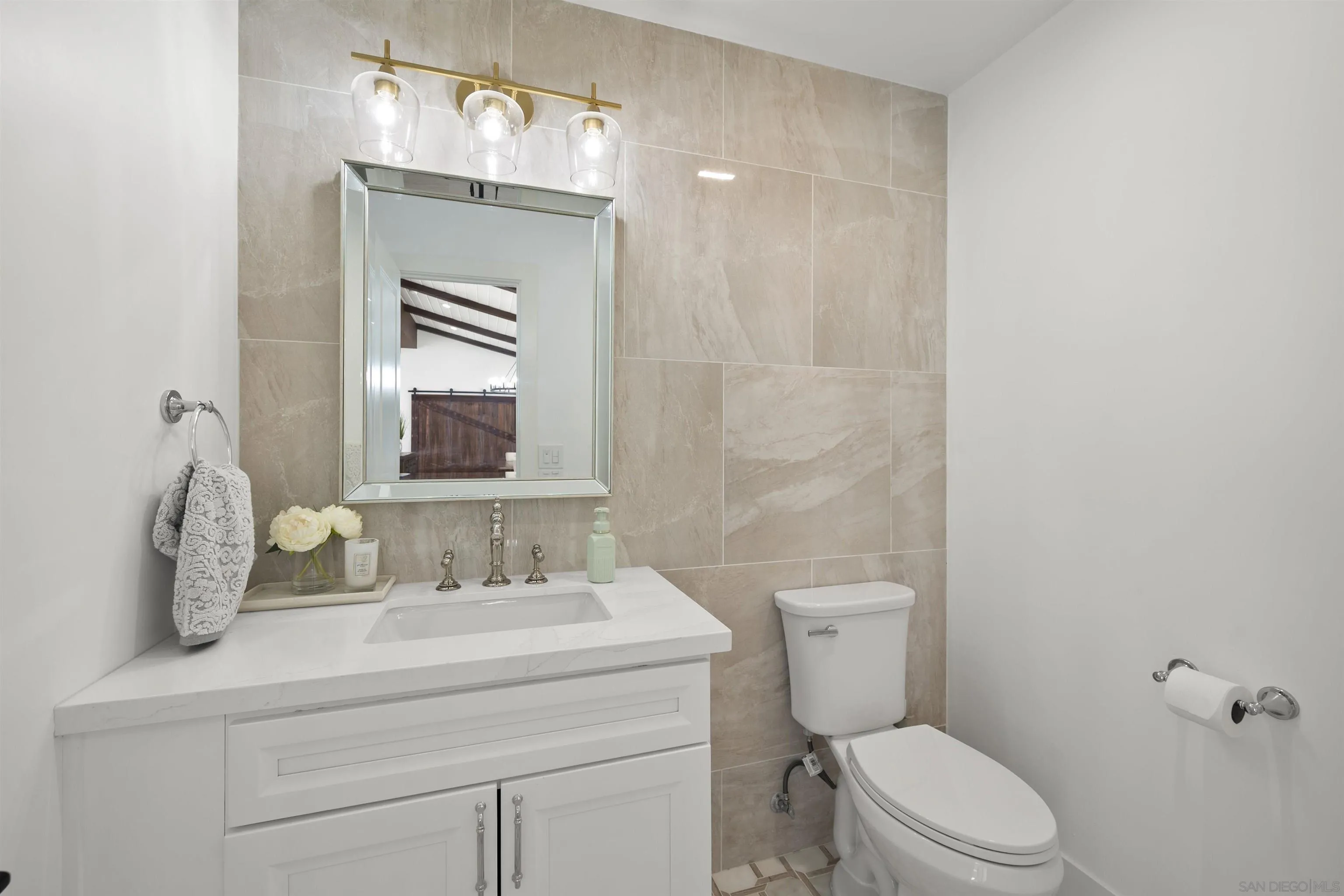 13367 Calle Colina Poway, CA 92064 - Photo 25 of 60 a bathroom with a toilet a sink and mirror