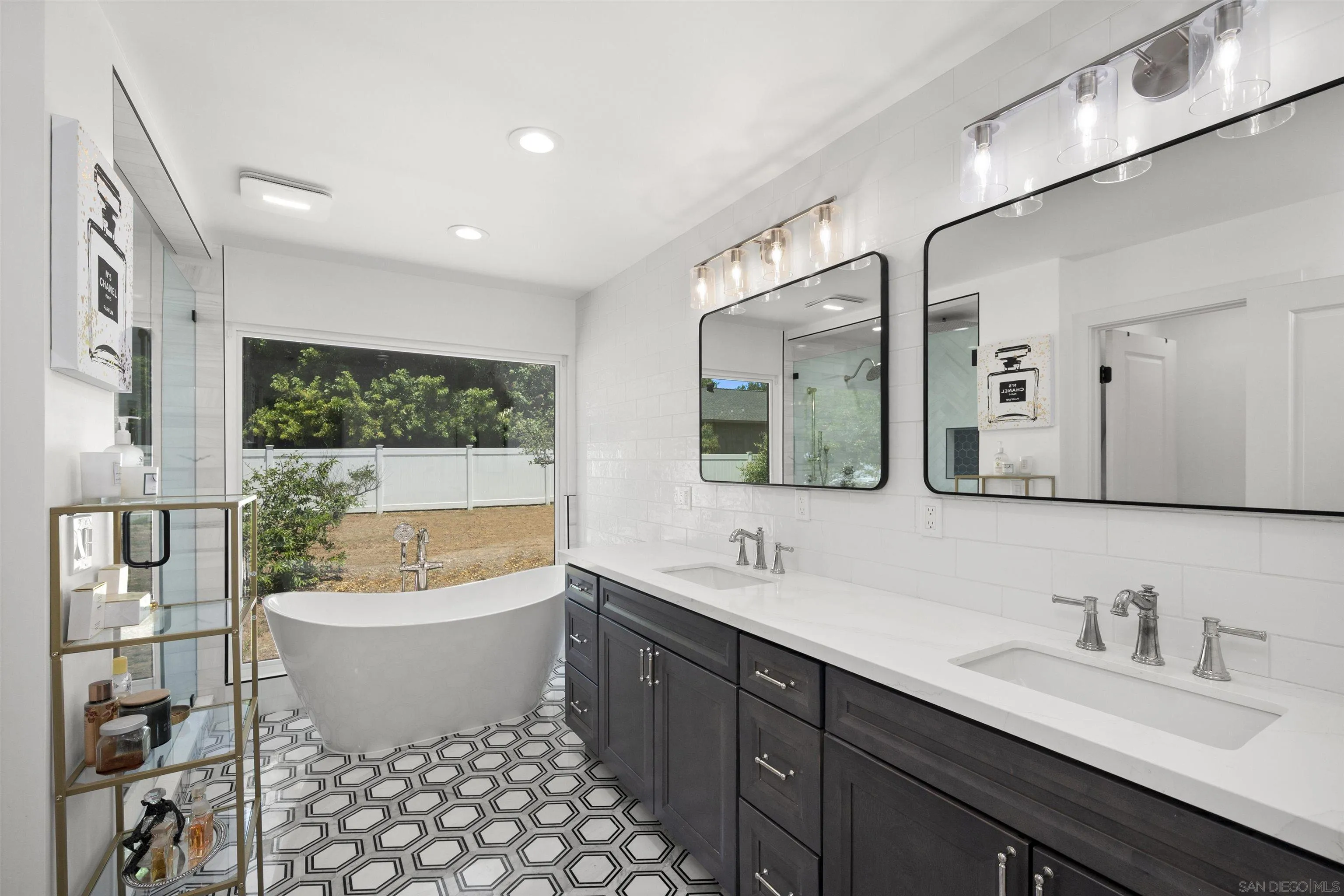 13367 Calle Colina Poway, CA 92064 - Photo 27 of 60 a bathroom with a double vanity sink a mirror and a bathtub