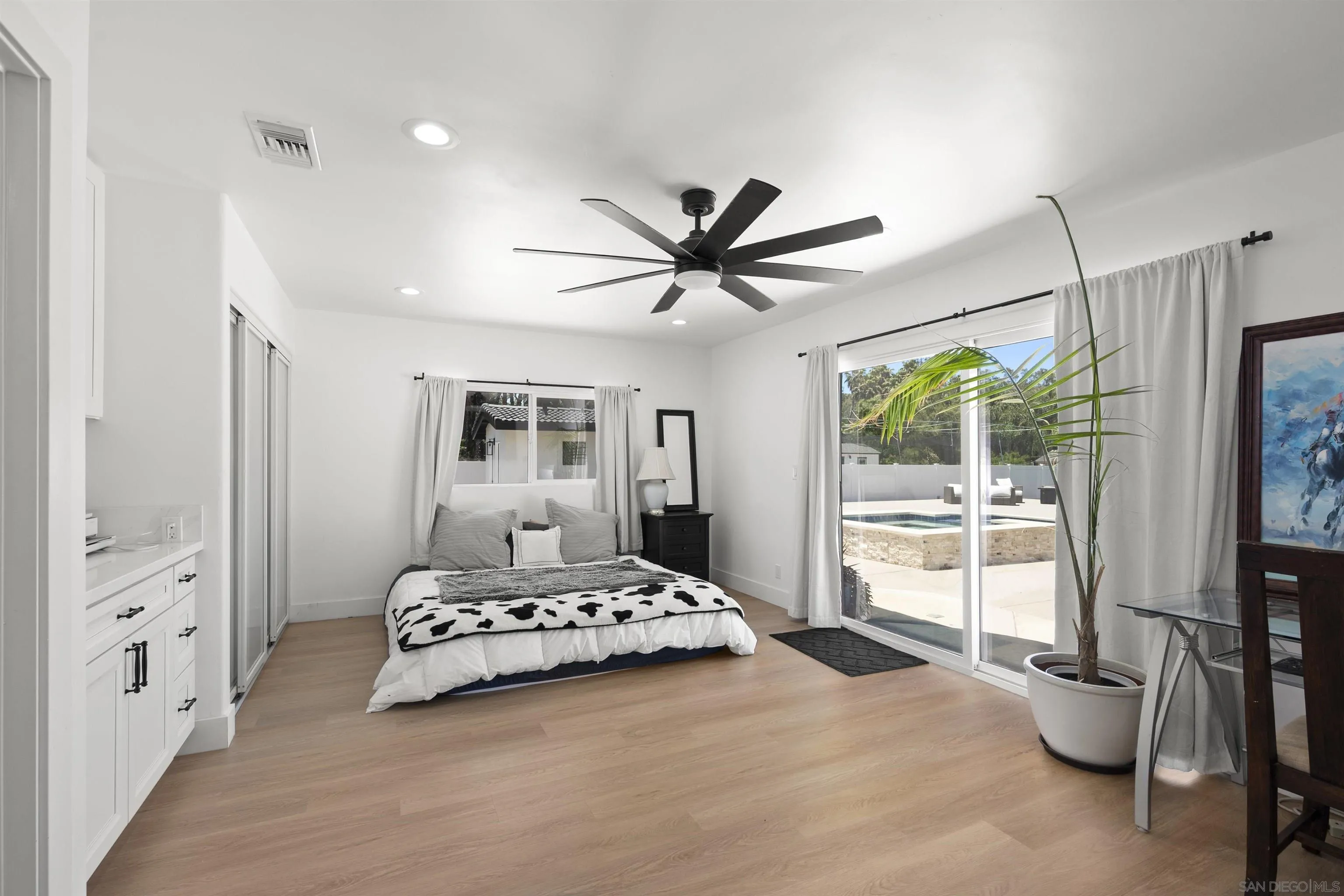 13367 Calle Colina Poway, CA 92064 - Photo 30 of 60 a bedroom with a large bed and a tv