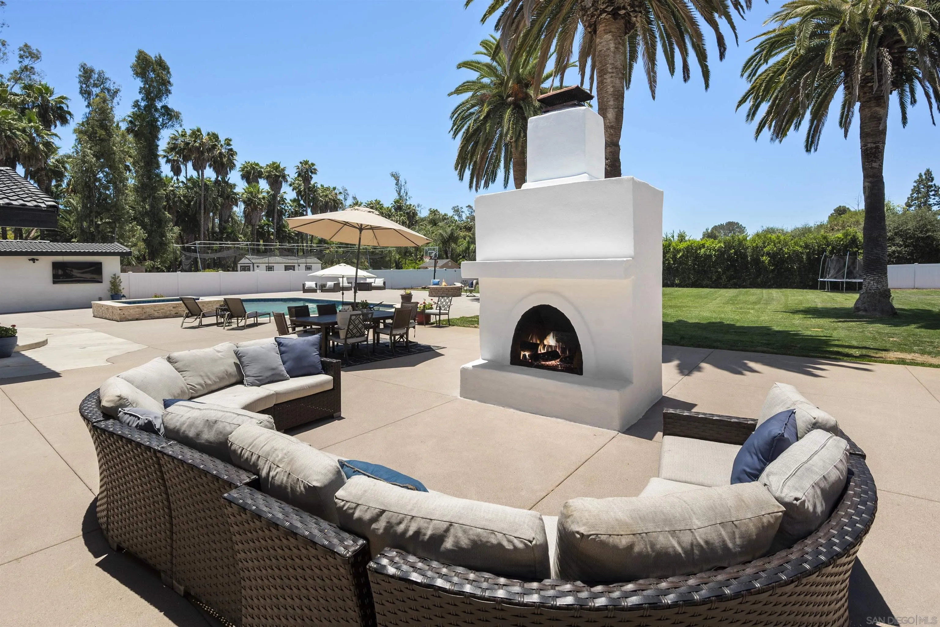 13367 Calle Colina Poway, CA 92064 - Photo 39 of 60 a view of a swimming pool with a couches chairs and a fire pit