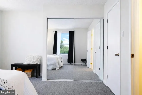 a bedroom with a bed and a couch