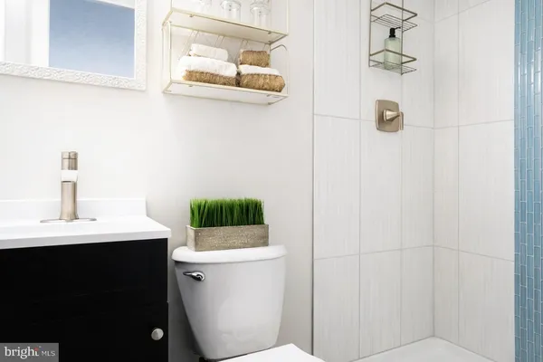 a bathroom with a sink a toilet and mirror