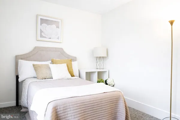 a bed room with a bed and a night stand