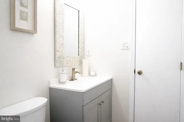 a bathroom with a sink a toilet and mirror