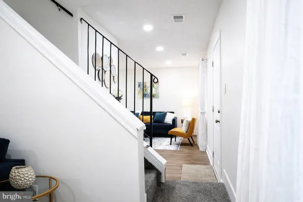 a view of entryway and hall with wooden floor