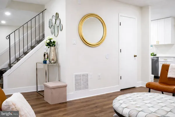 a view of a livingroom with furniture and staircase