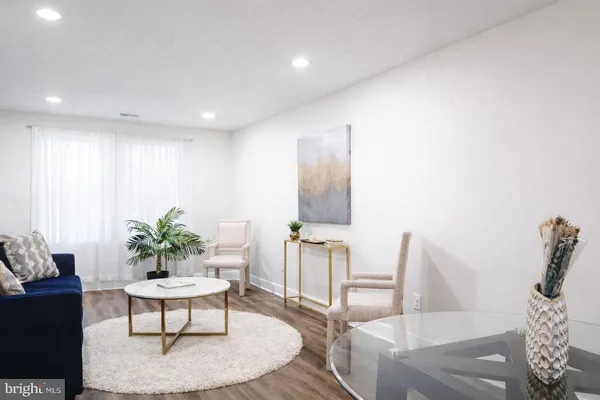 a living room with furniture and a potted plant