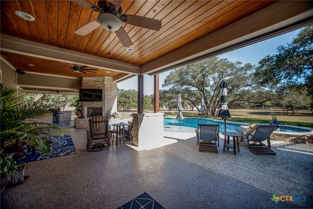 437 Bischoff Road Inez, TX 77968 - Photo 33 of 47 a view of a patio with table and chairs potted plants and floor to ceiling window
