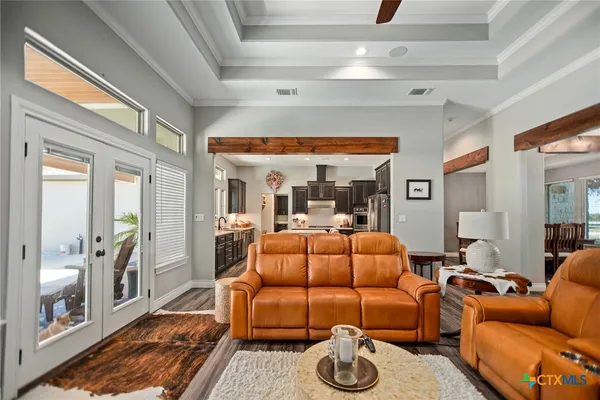 a living room with furniture a flat screen tv and a floor to ceiling window